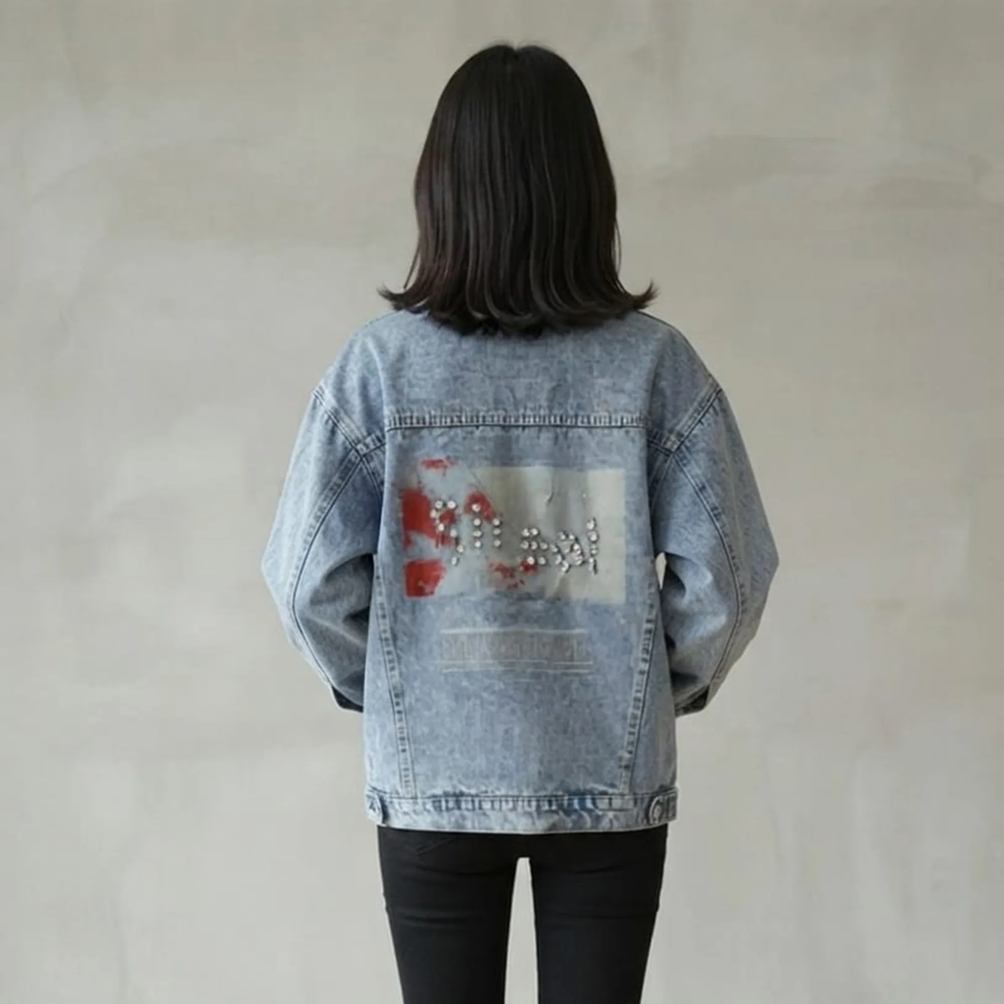Light-wash-oversized-graphic-denim-jacket-for-women-with-button-front-and-back-print