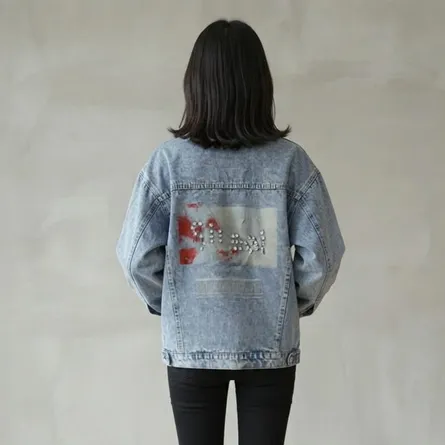 Light-wash-oversized-graphic-denim-jacket-for-women-with-button-front-and-back-print