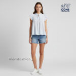 Pastel-blue-Aqaba-eyelet-embroidered-sleeveless-top-with-ruffle-sleeves-and-tie-up-neck