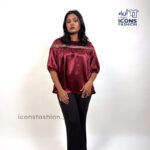 Wine-red-top-with-lace-detailing-across-the upper-chest-and-shoulders