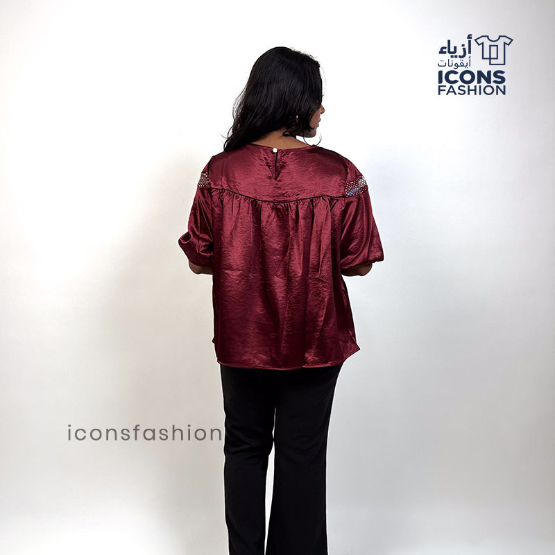 Wine-red-top-with-lace-detailing-across-the upper-chest-and-shoulders