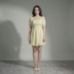 Women-yellow-eyelet-mini-dress-with-square-neck-puff-sleeves-smocked-waist-and-fit-and-flare-silhouette