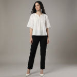 Women-off-white-embroidered-top-with-round-notch-neckline-elbow-length-flared-sleeves-with-fringe-trim-relaxed-fit-and-hip-length-straight-hem