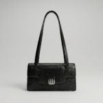 Black-structured-shoulder-bag-with-flap-closure-and-long-straps-textured-handbag