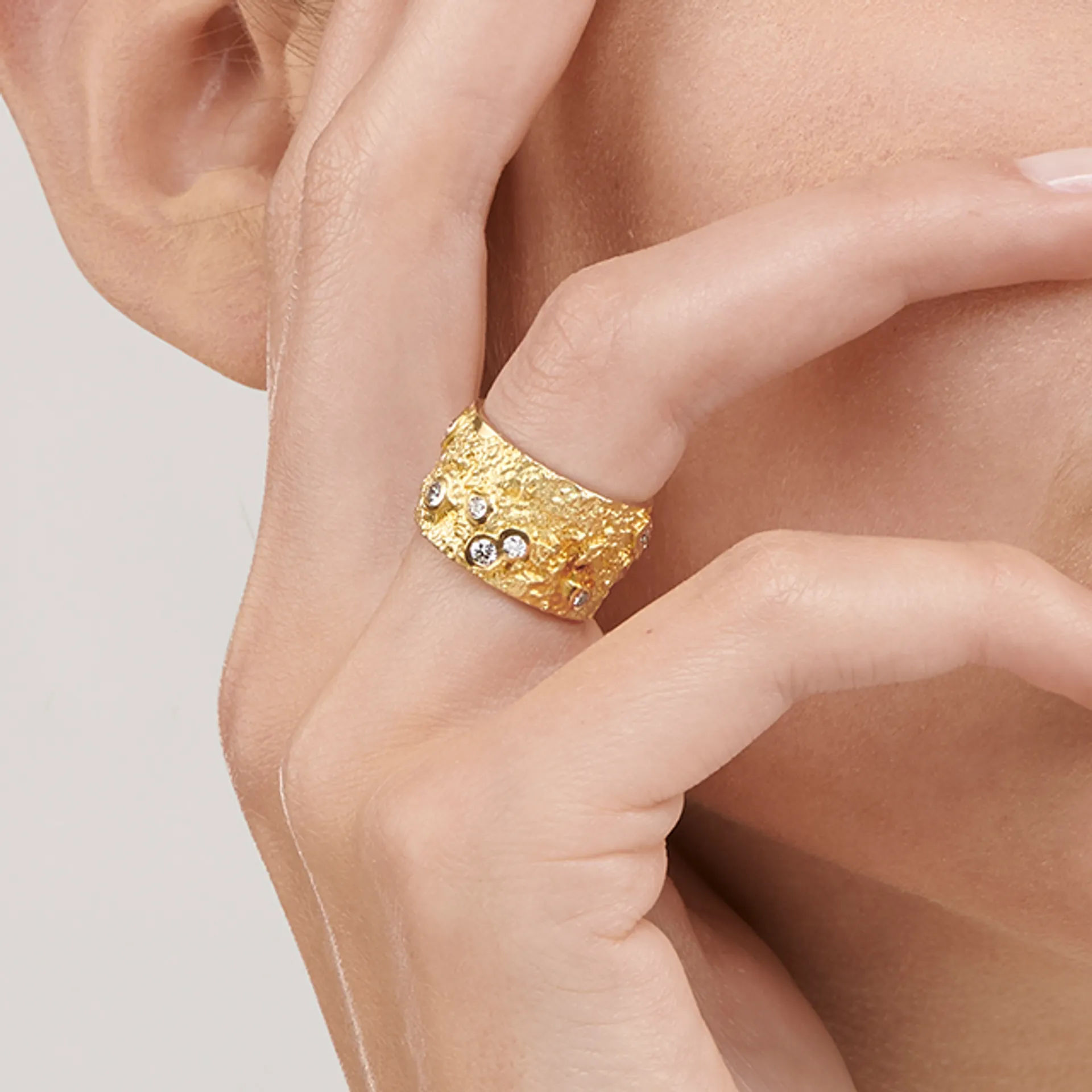 Close up image of the Ténéré Alliance Yellow Gold Ring with Diamonds designed by Thierry Vendôme worn by @celinemarechal
