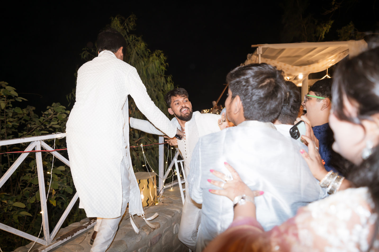 Guests pulling each other into the celebration at night