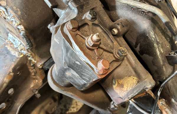 Back to current time. I had to remove a little of the extra cast iron on this steering box to give me more clearance between the box and the engine timing cover. I used a 9" grinder while the engine was in place, and finally with the engine off the frame, I can clean it up with a flap disc. Back to current time. I had to remove a little of the extra cast iron on this steering box to give me more clearance between the box and the engine timing cover. I used a 9" grinder while the engine was in place, and finally with the engine off the frame, I can clean it up with a flap disc.
