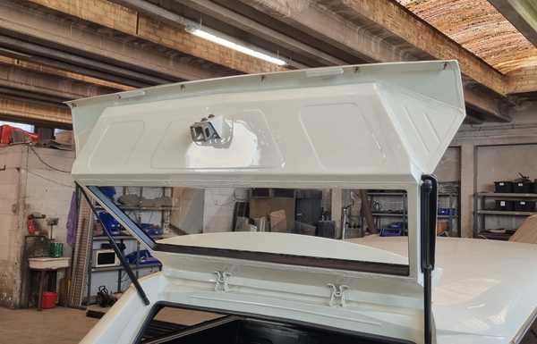 Liftgate with modern shocks that will be hidden in the water gutter when the gate's closed Liftgate with modern shocks that will be hidden in the water gutter when the gate's closed