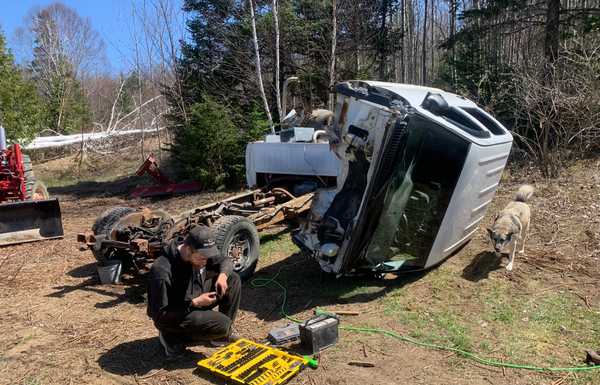 Gentle disassembly of donor truck using tractor.