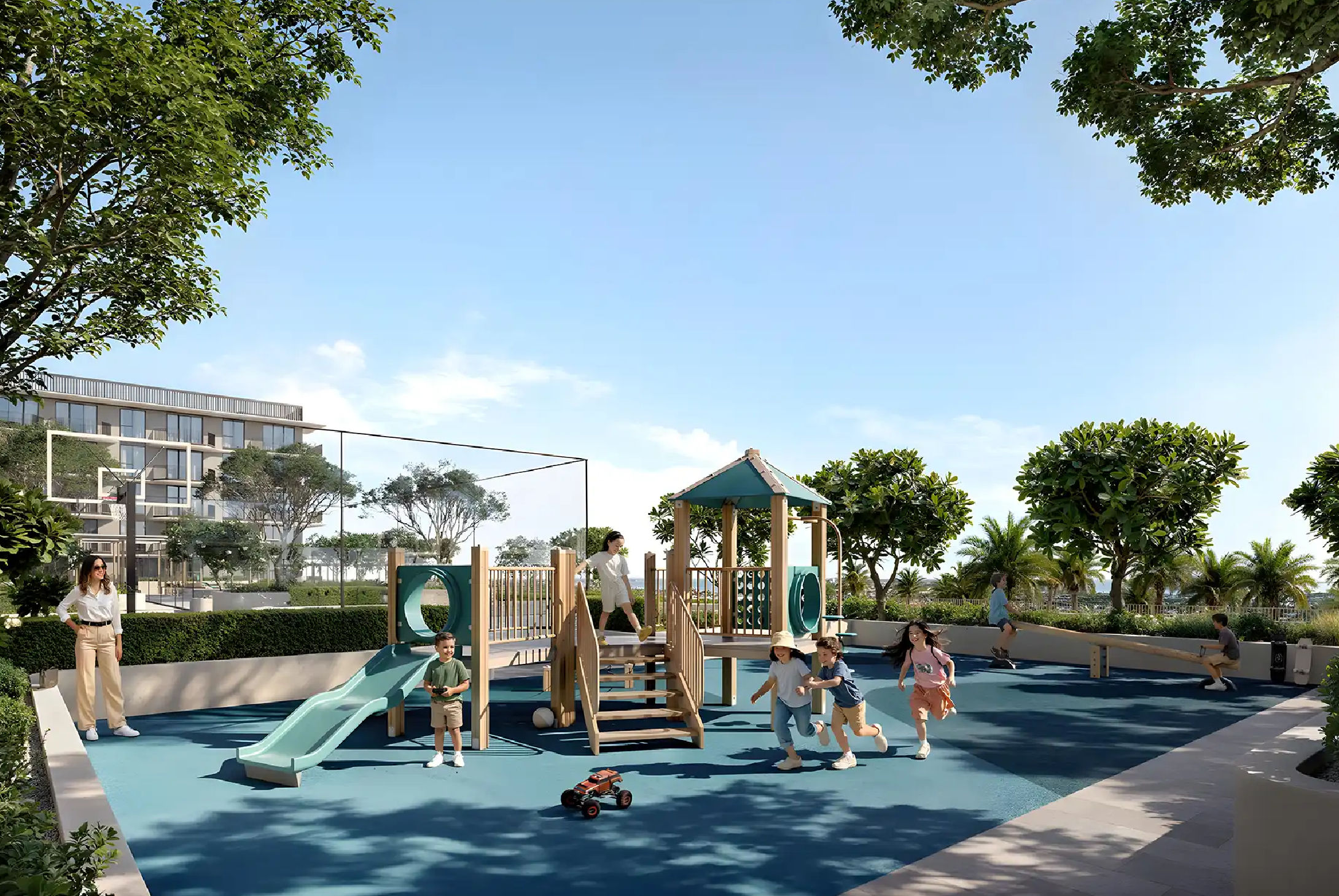 View of Yachtside Marina Residences at sunset with buildings, palm trees, and beach