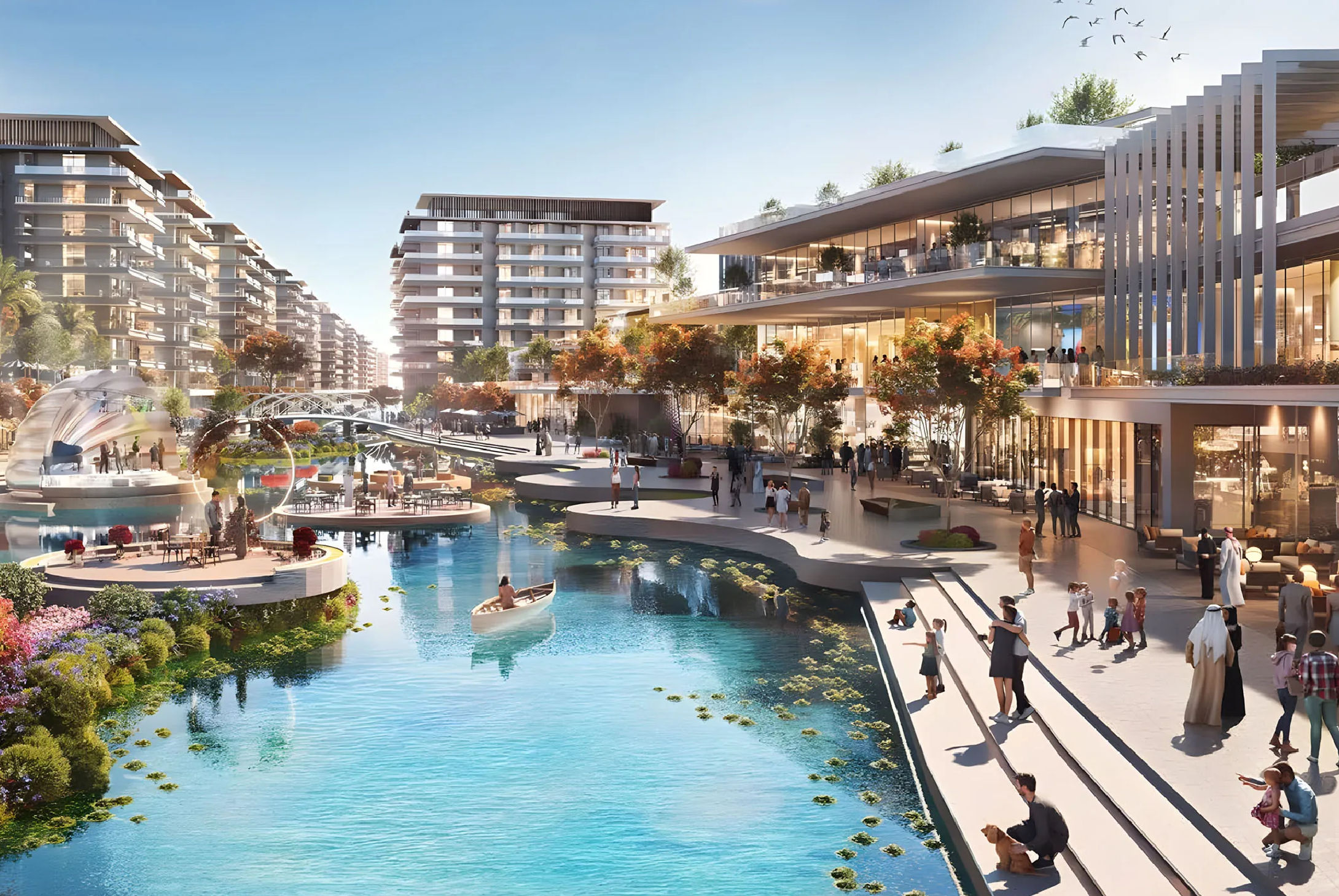 View of Yachtside Marina Residences at sunset with buildings, palm trees, and beach