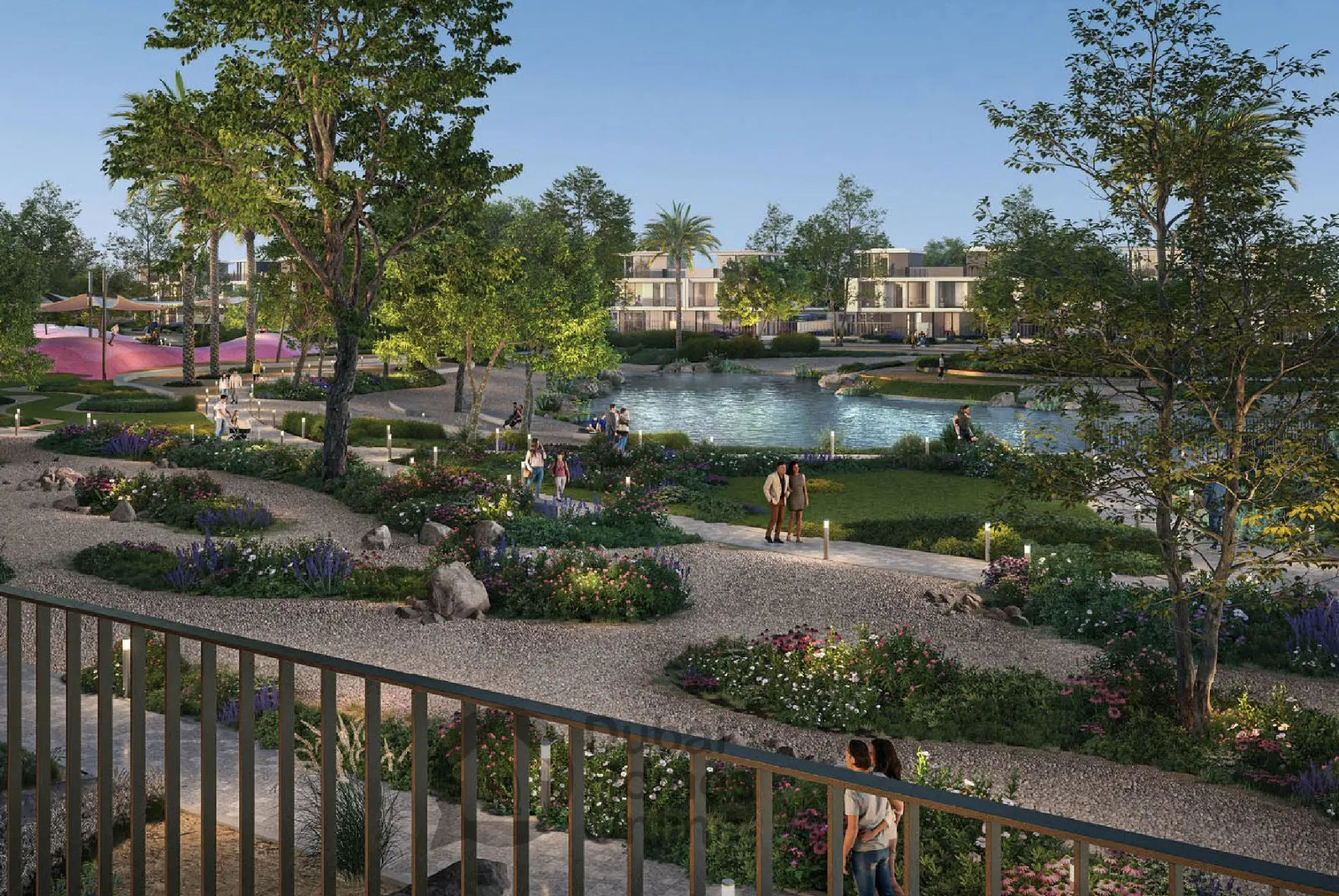 View of Yachtside Marina Residences at sunset with buildings, palm trees, and beach