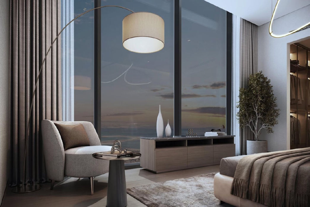 View of Yachtside Marina Residences at sunset with buildings, palm trees, and beach