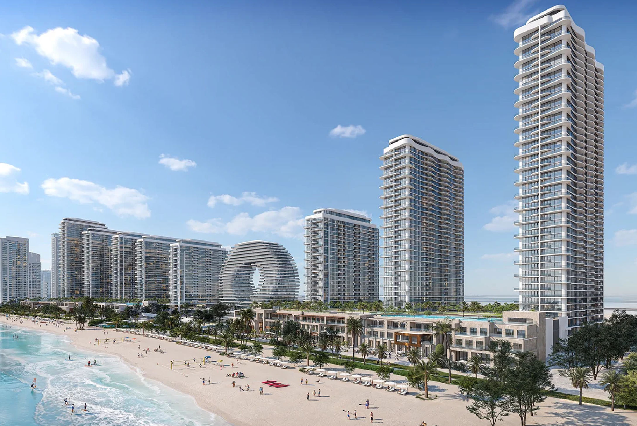View of Yachtside Marina Residences at sunset with buildings, palm trees, and beach
