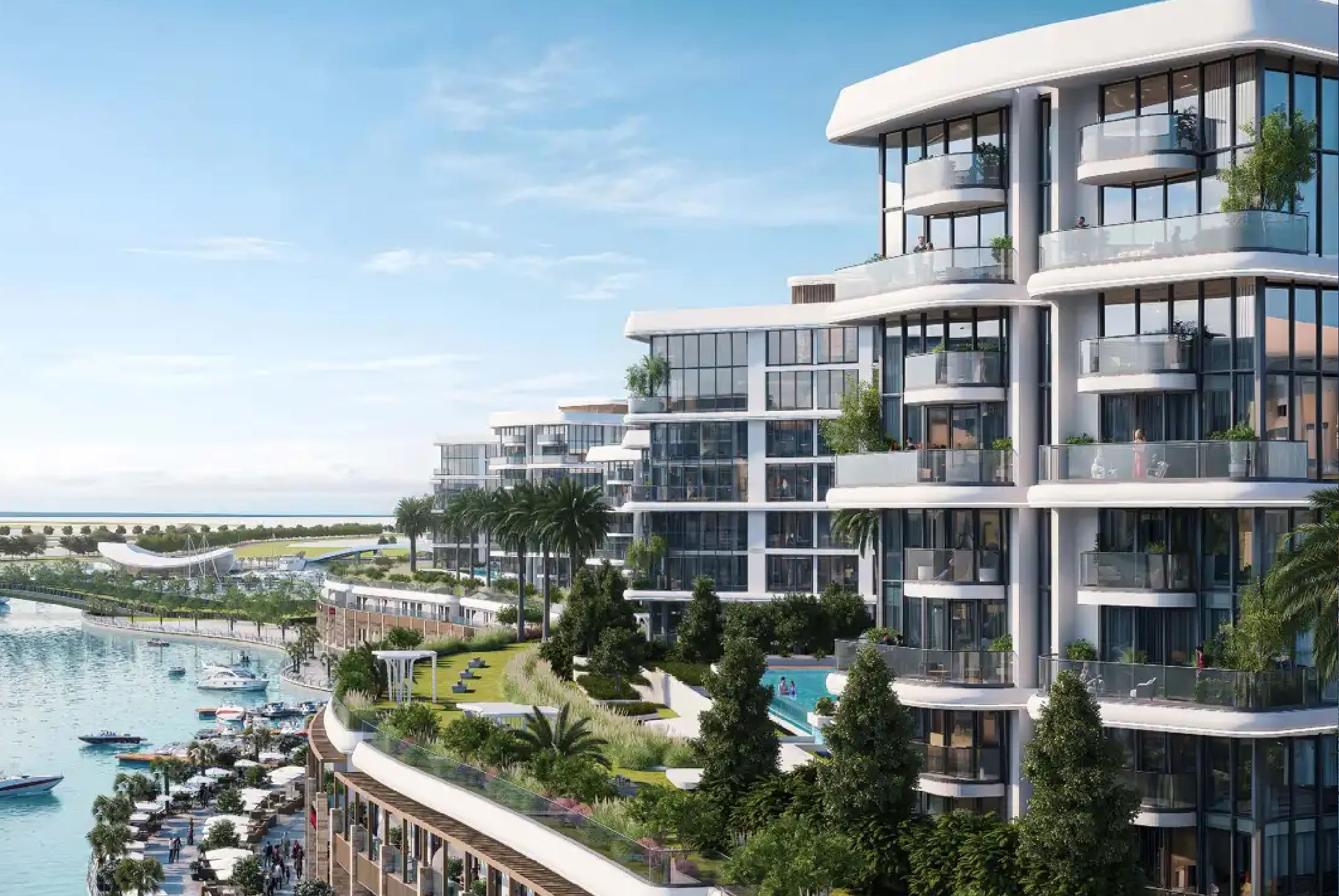 View of Yachtside Marina Residences at sunset with buildings, palm trees, and beach