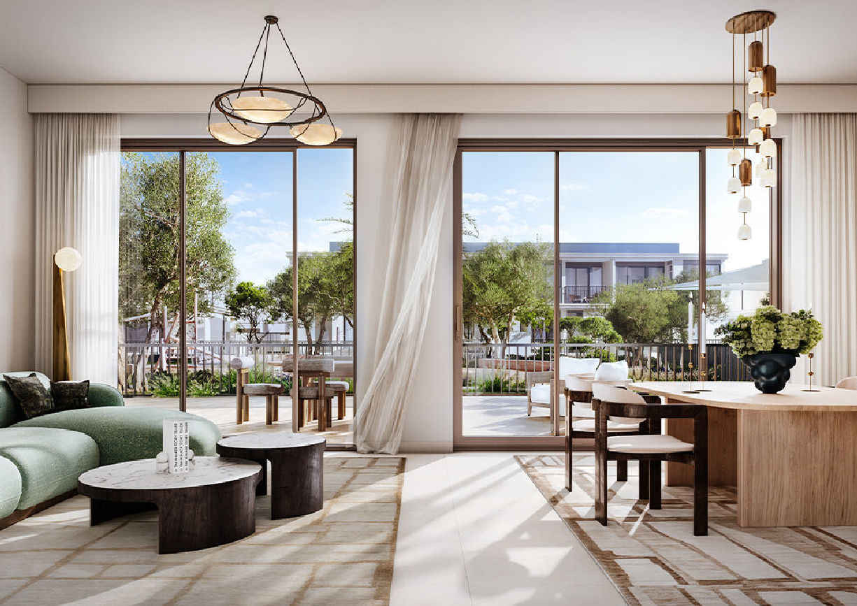 View of Yachtside Marina Residences at sunset with buildings, palm trees, and beach