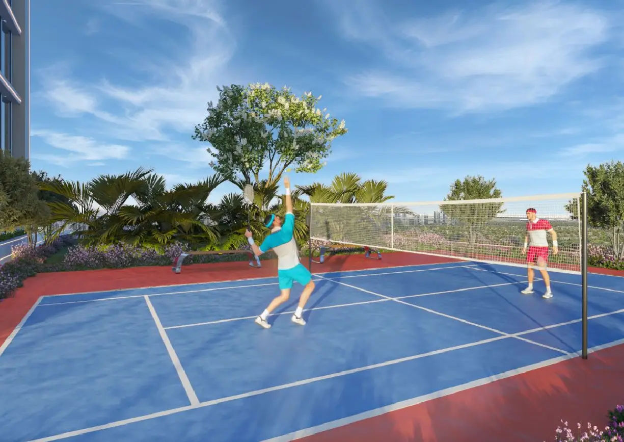 View of Yachtside Marina Residences at sunset with buildings, palm trees, and beach