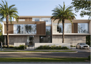 View of Yachtside Marina Residences at sunset with buildings, palm trees, and beach
