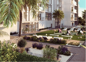View of Yachtside Marina Residences at sunset with buildings, palm trees, and beach