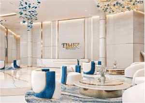 View of Yachtside Marina Residences at sunset with buildings, palm trees, and beach