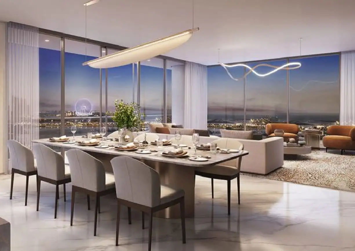 View of Yachtside Marina Residences at sunset with buildings, palm trees, and beach