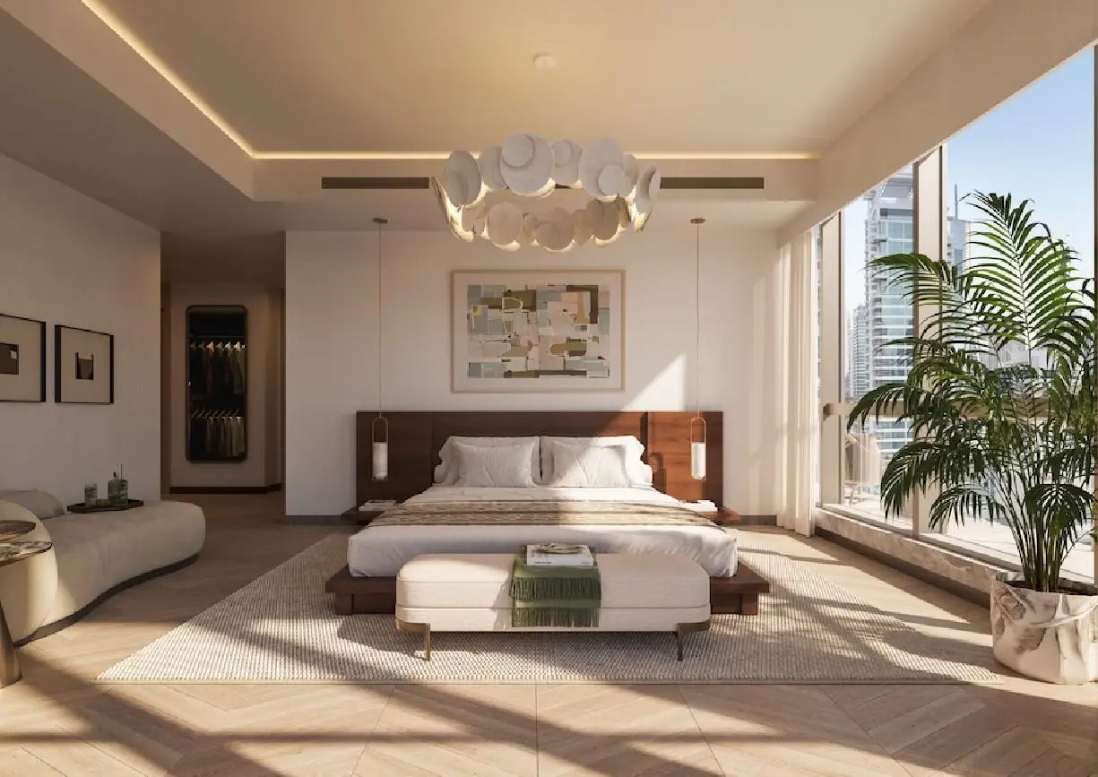 View of Yachtside Marina Residences at sunset with buildings, palm trees, and beach