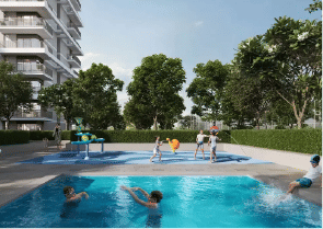 View of Yachtside Marina Residences at sunset with buildings, palm trees, and beach