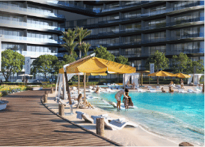 View of Yachtside Marina Residences at sunset with buildings, palm trees, and beach