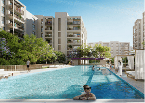 View of Yachtside Marina Residences at sunset with buildings, palm trees, and beach