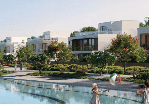 View of Yachtside Marina Residences at sunset with buildings, palm trees, and beach