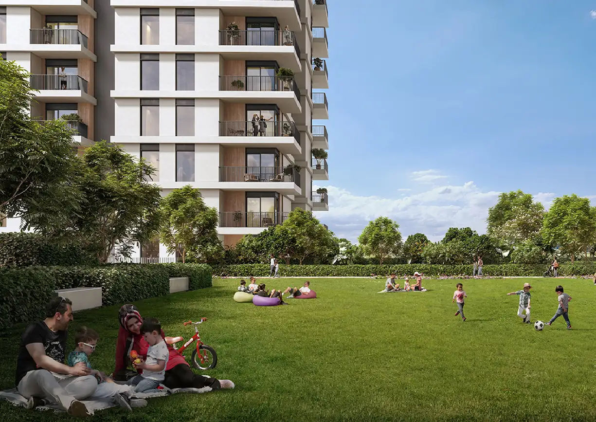 View of Yachtside Marina Residences at sunset with buildings, palm trees, and beach