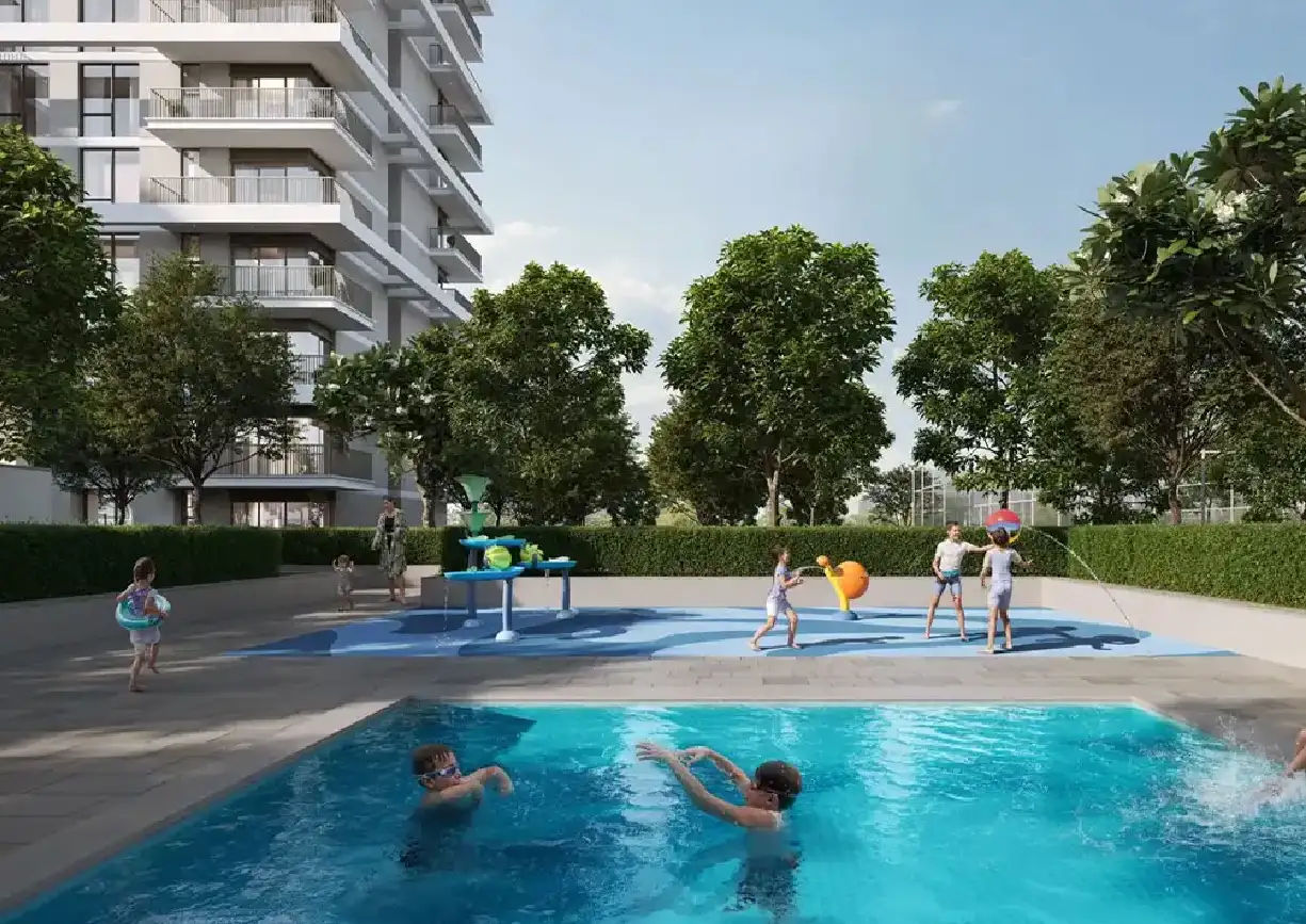 View of Yachtside Marina Residences at sunset with buildings, palm trees, and beach