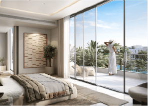 View of Yachtside Marina Residences at sunset with buildings, palm trees, and beach