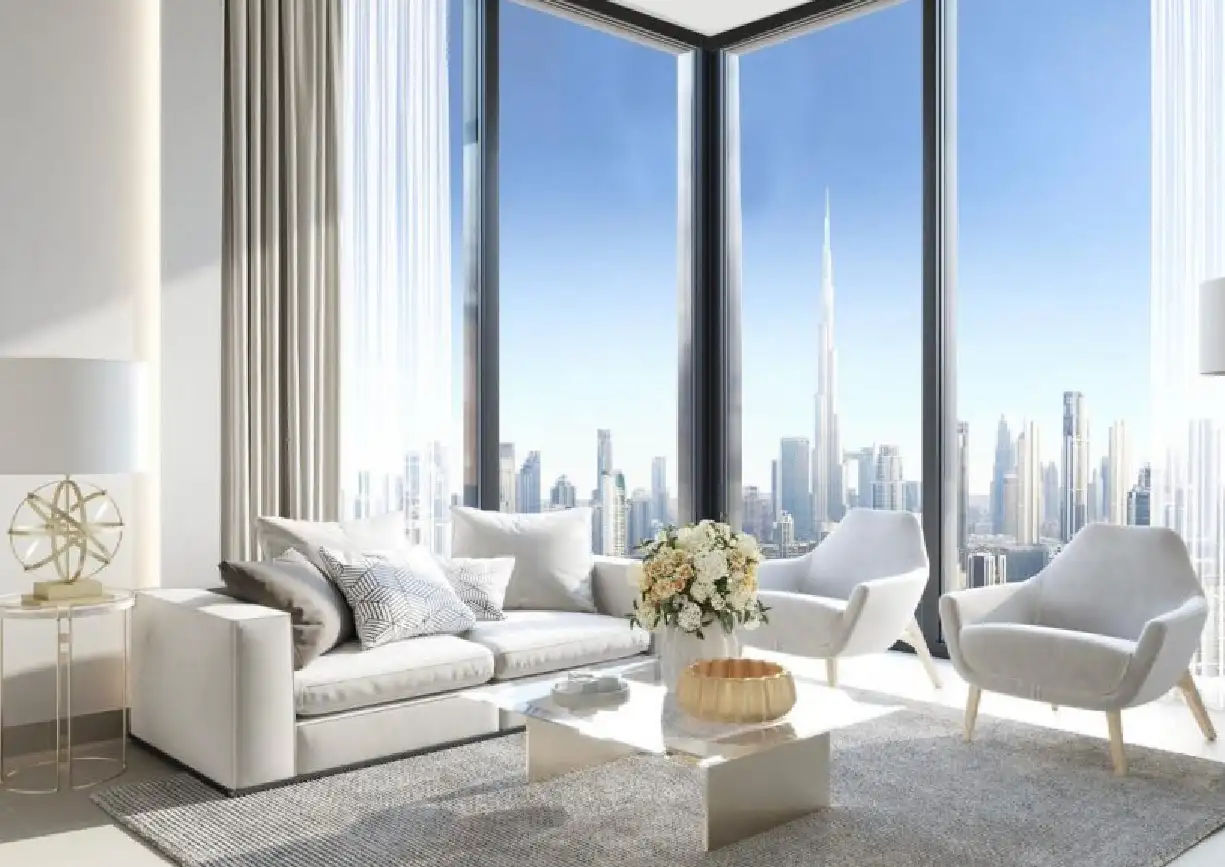 View of Yachtside Marina Residences at sunset with buildings, palm trees, and beach