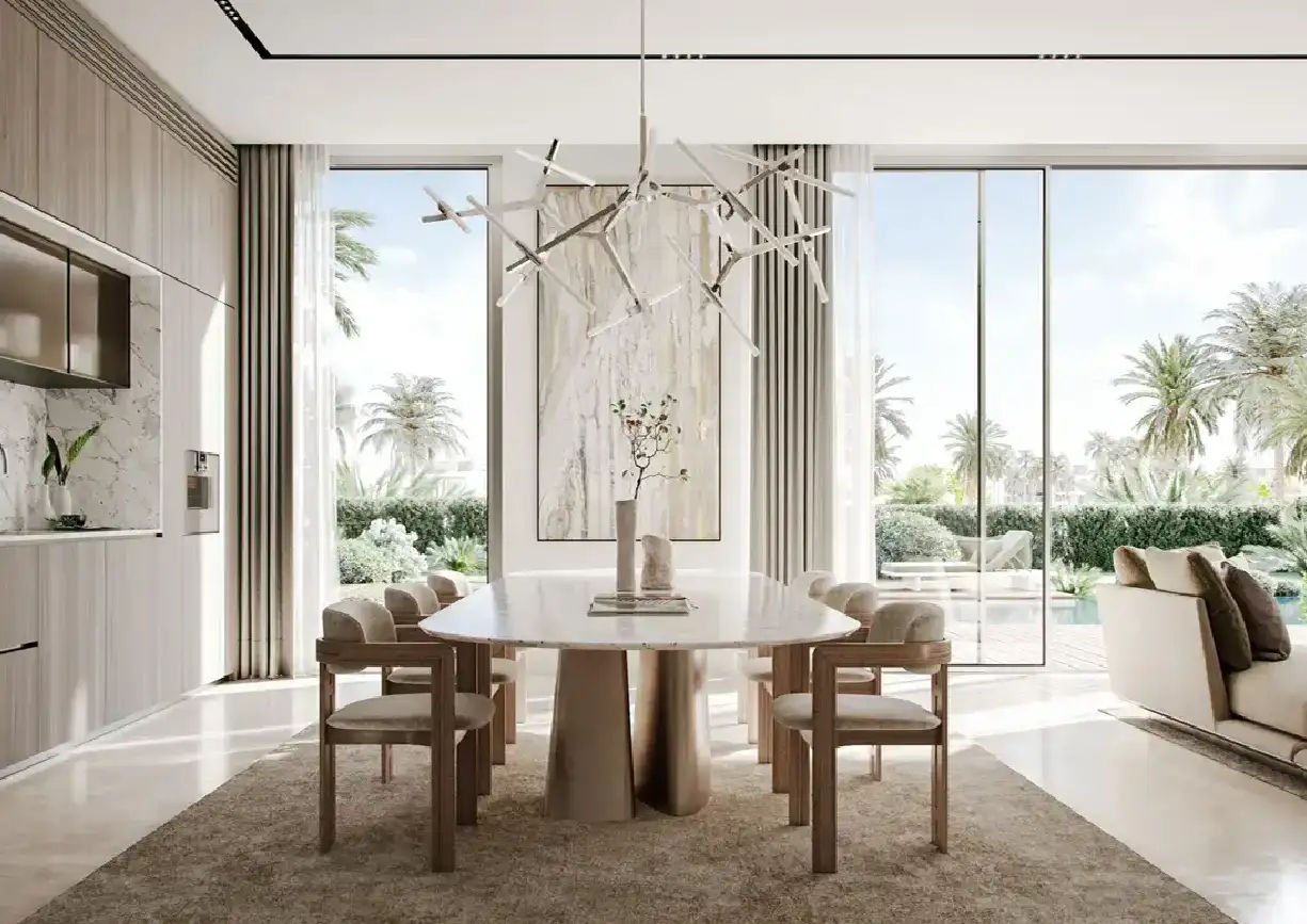 View of Yachtside Marina Residences at sunset with buildings, palm trees, and beach