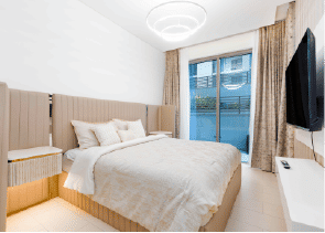 Interior view of a bedroom in Yachtside Marina Residences with large window and modern decor