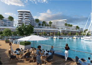 View of Yachtside Marina Residences at sunset with buildings, palm trees, and beach