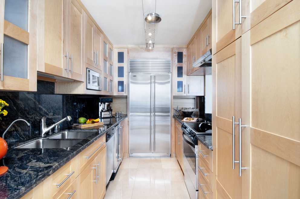 Modern Galley Apartment Kitchen With Natural Wood Cabinetry (Photo 21 of 30)