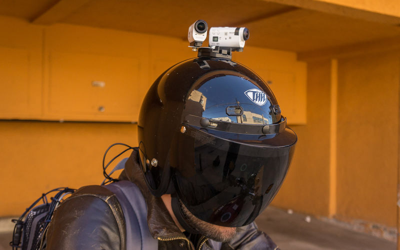 Person wearing motorcycle helmet with cameras