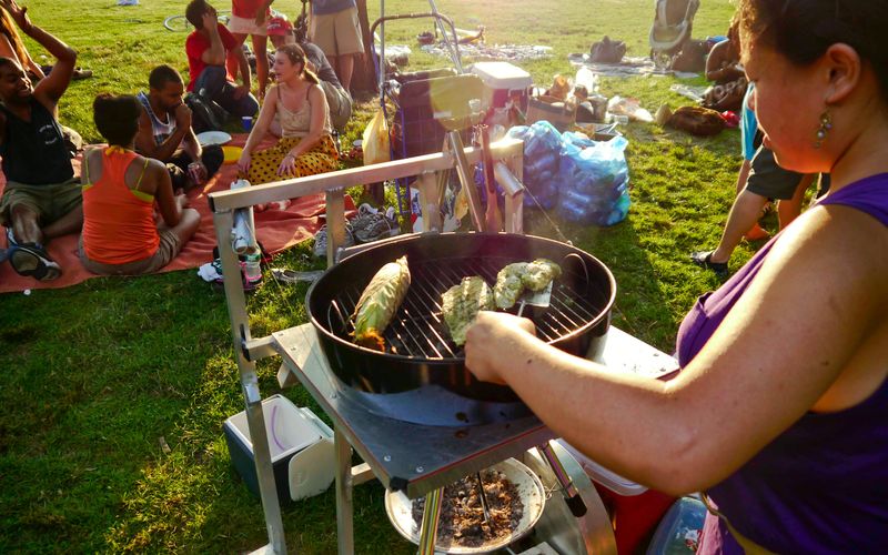 Woman grilling with friends in a park