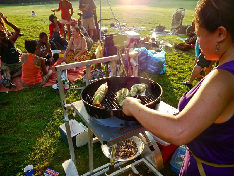 Woman grilling with friends in a park