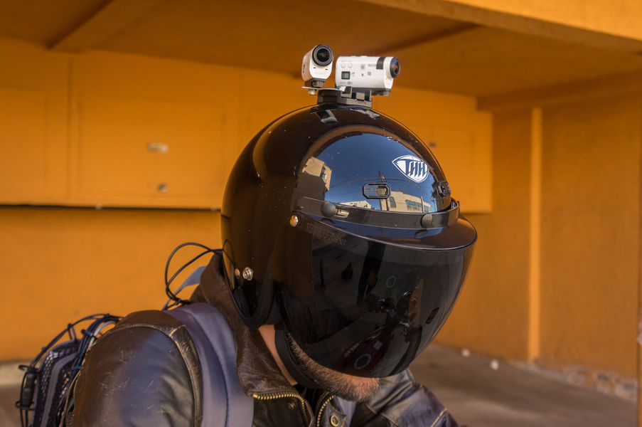 Person wearing motorcycle helmet with cameras