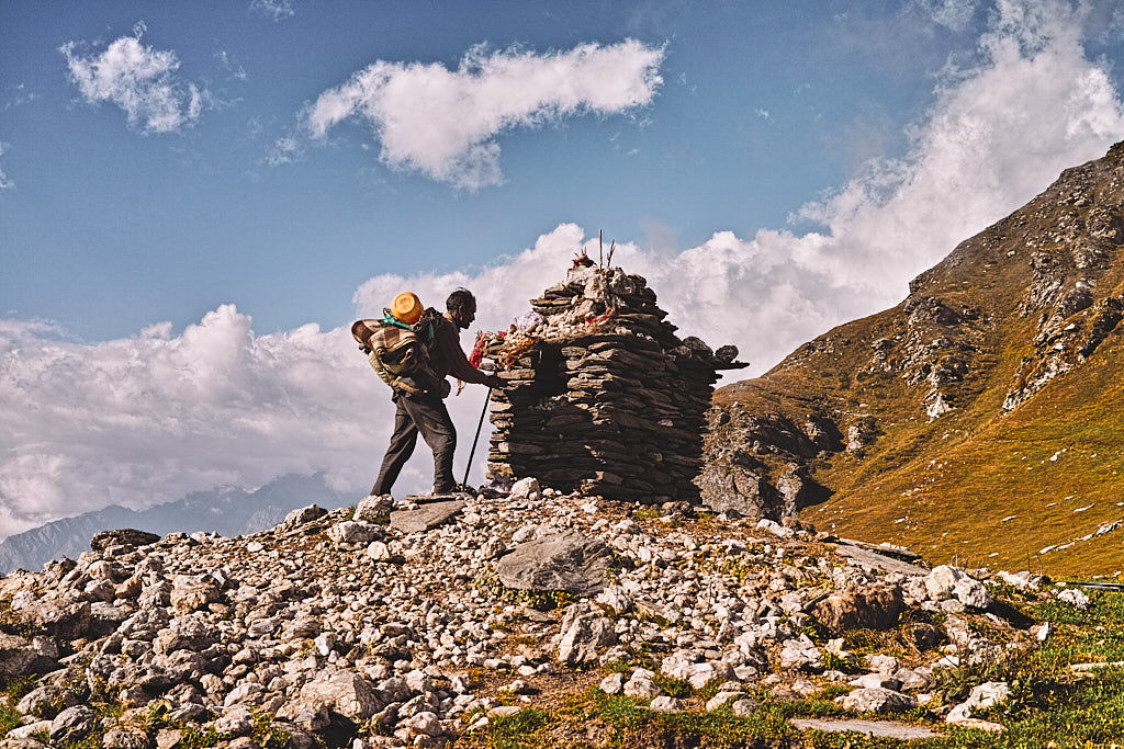 Gaddi praying to the cairn temple at the top of Jalsu Pass