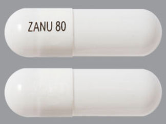 Esto es un Cápsula imprimido con ZANU 80 en la parte delantera, nada en la parte posterior, y es fabricado por None.