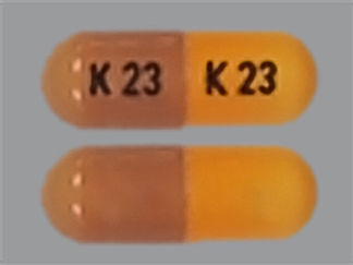 Esto es un Cápsula imprimido con K 23 en la parte delantera, K 23 en la parte posterior, y es fabricado por None.