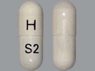 Esto es un Cápsula imprimido con H en la parte delantera, S2 en la parte posterior, y es fabricado por None.