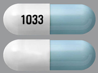 This is a Capsule imprinted with 1033 on the front, nothing on the back.