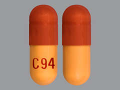 This is a red oblong Capsule imprinted with C 94 on the front, nothing on the back, and is manufactured by MODAVAR PHARMAC.