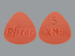 This is a red triangular Tablet imprinted with Pfizer on the front, 5  XNB on the back, and is manufactured by PFIZER US PHARM.