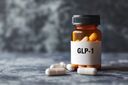 A clear vial labeled GLP1 that represents medications associated with GLP1 therapy